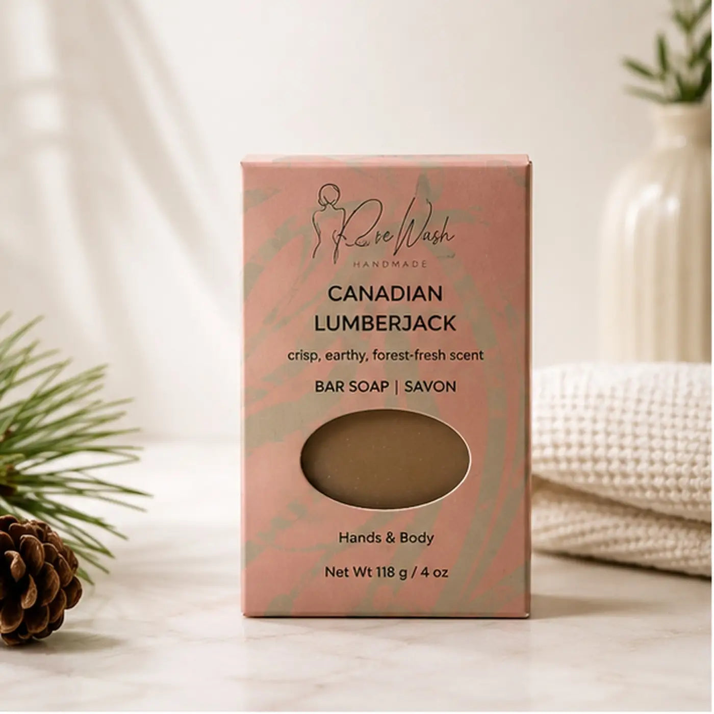 Pink rectangular box containing beige handcrafted canadian lumberjack soap bar by rose wash for bathing routine