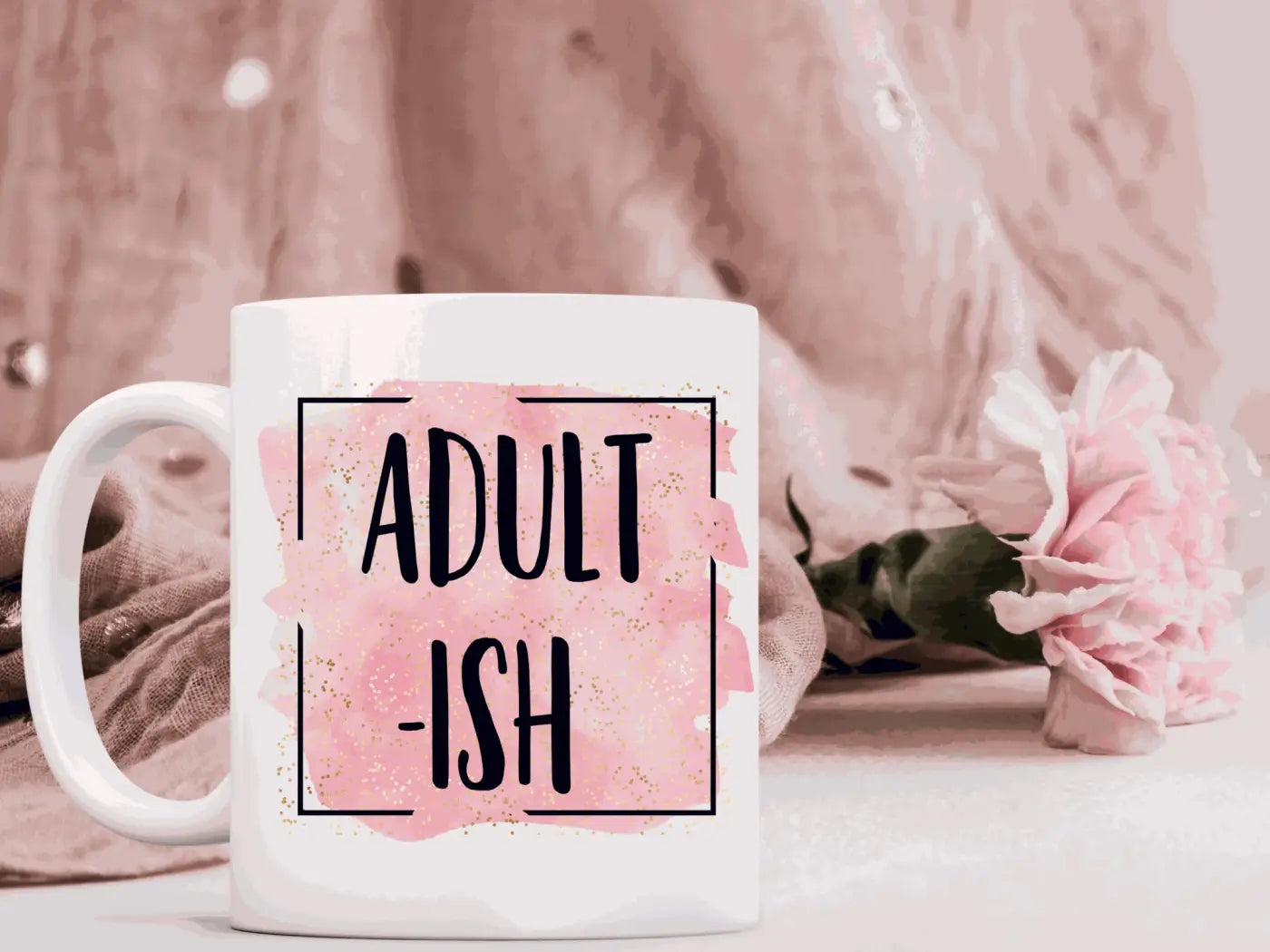 White ceramic mug with adult ish text on pink watercolor background framed by black border in ceramic mugs 11 oz