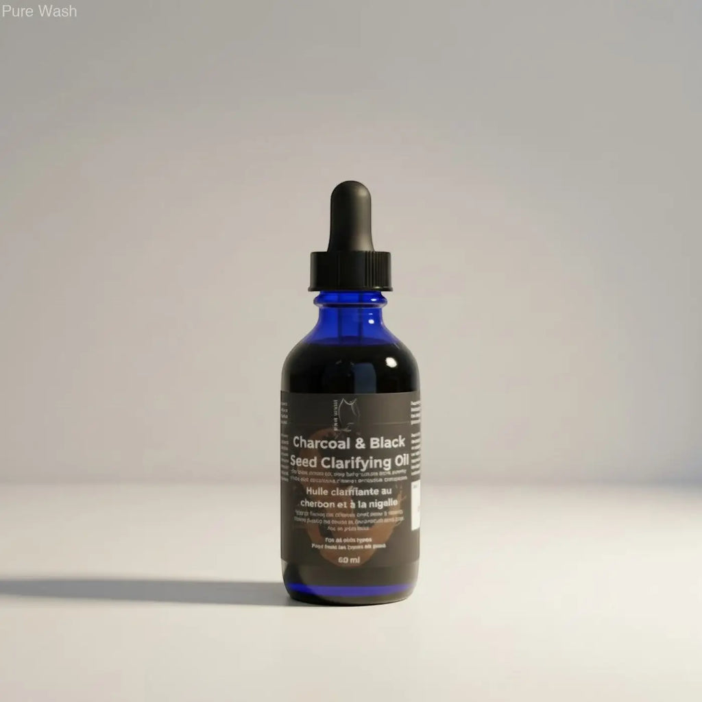 A sleek blue glass bottle with black dropper cap labeled charcoal and black seed clarifying oil by Pure Wash balances sebum production