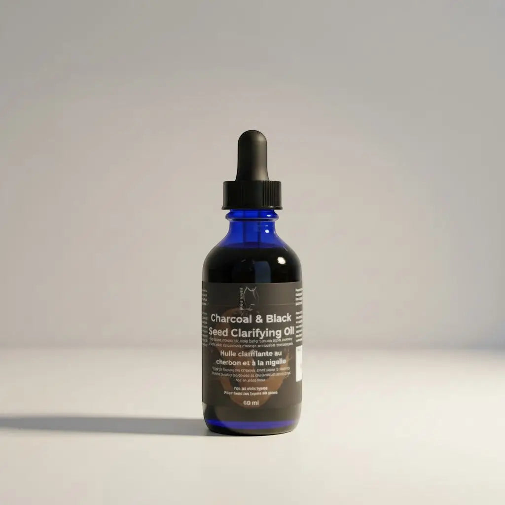 A sleek blue glass bottle with black dropper cap containing charcoal and black seed clarifying oil refill station