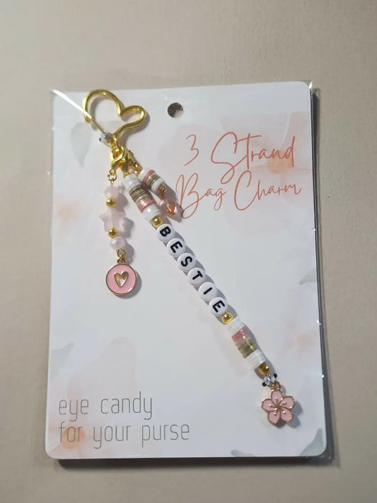Charm 1 is a delicate pink and gold handmade soap canada bag charm with bestie letter beads heart and floral charms
