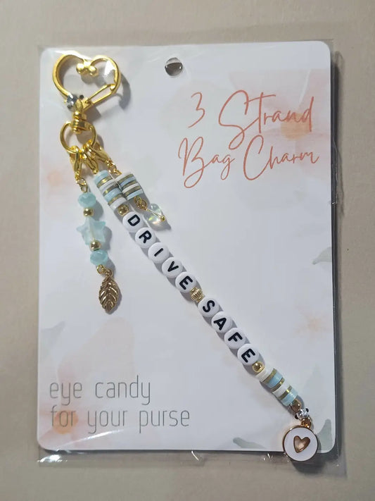 Gold-toned charm 5 keychain with drive safe beads, blue white striped charms, gold leaf pendant, heart clasp, ideal for direct sunlight protection