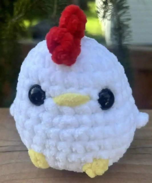 A white crocheted chicken with red comb black eyes and yellow beak and feet ideal for natural skincare canada decor