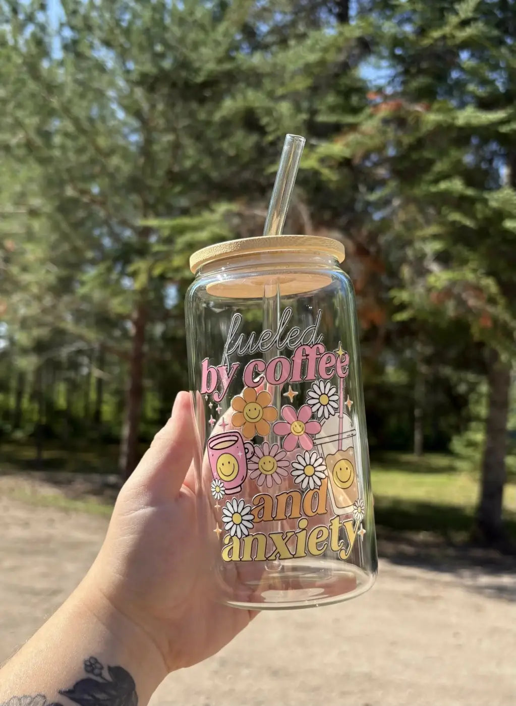 Clear glass anxiety cup with bamboo lid and glass straw featuring pink yellow and white floral and coffee decals