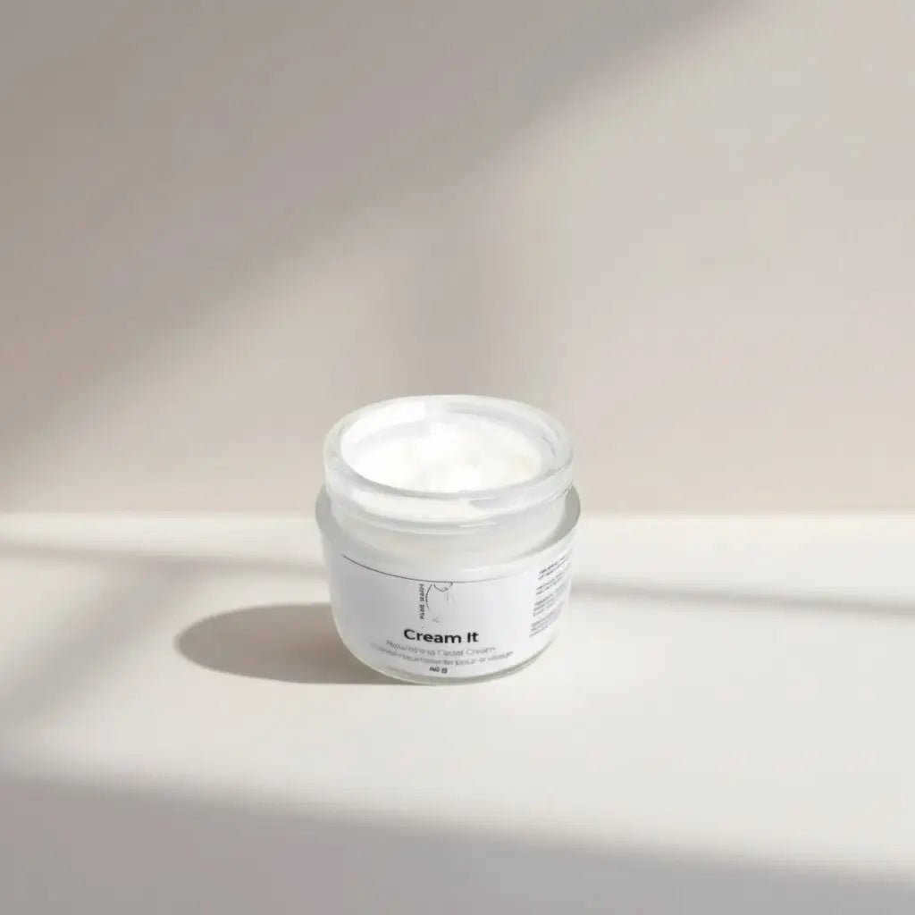 A minimalist white jar of cream it nourishing moisturizer with a clear lid and clean typography for mature skin with shea butter