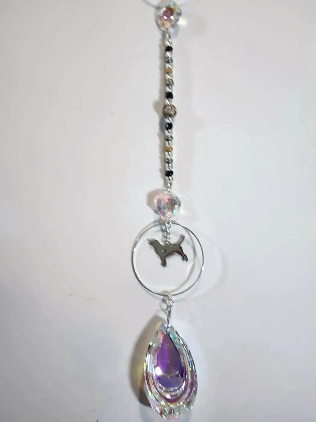 Dog 1 long suncatcher with silver chain, clear and black beads, dog silhouette charm, and iridescent teardrop ornament