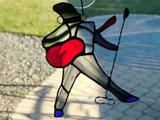 Handmade stained glass elvis presley figure ornament of a skier in black silver red with blue accents