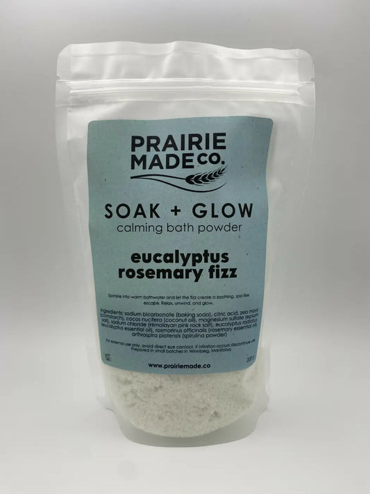 A light blue and white resealable pouch of prairie made co. eucalyptus rosemary fizz calming bath powder for glow calming bath use