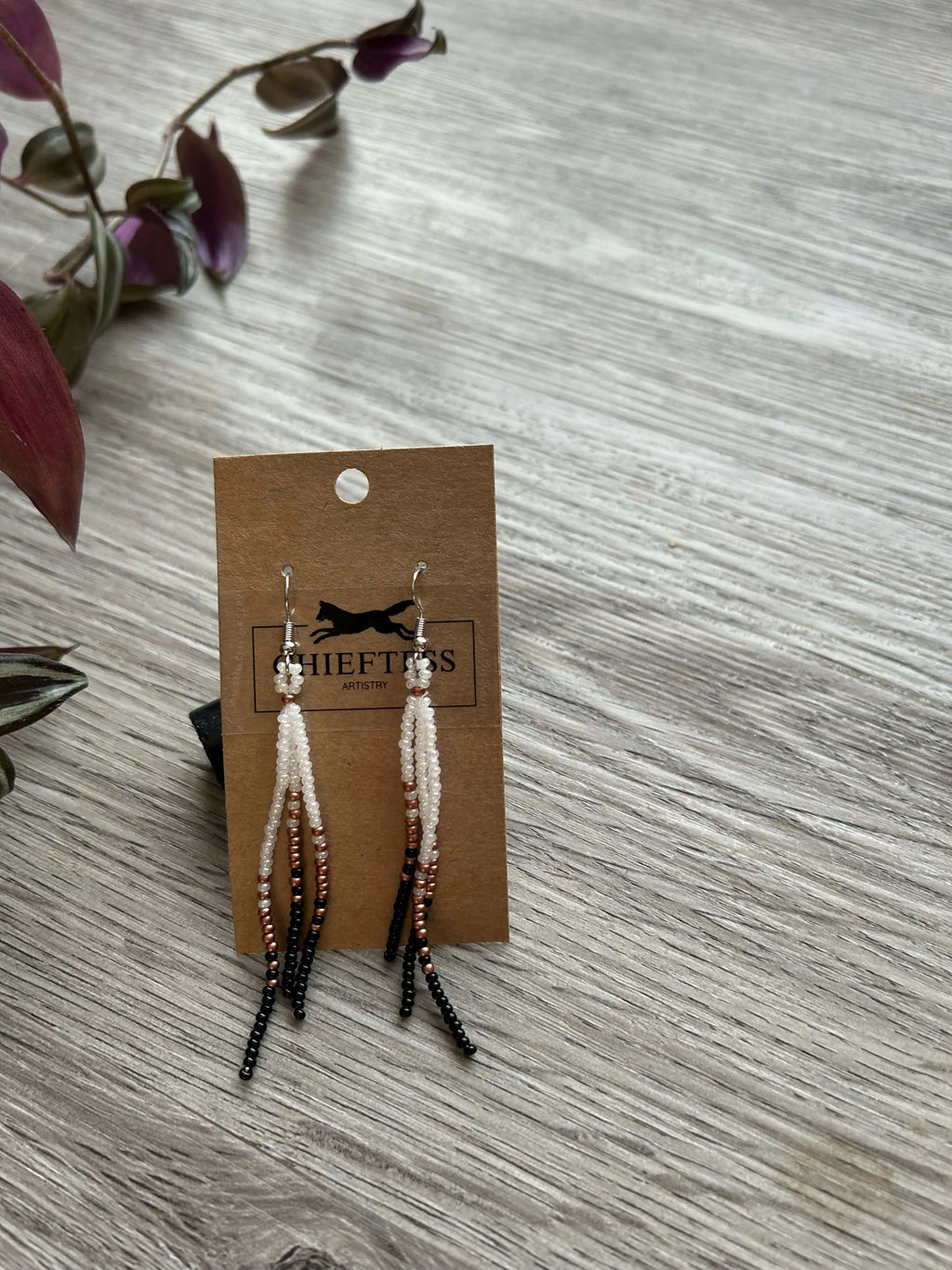 Dangle beaded earrings with three delicate strands, approximately 3 inches in length, displayed on a card with decorative plants.