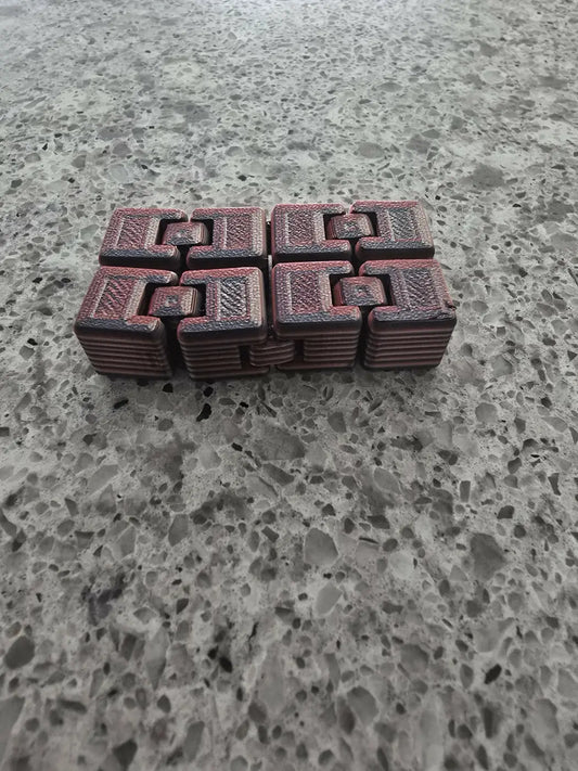 Red textured figet cube with interlocking geometric patterns crafted for stress relief and focus enhancement