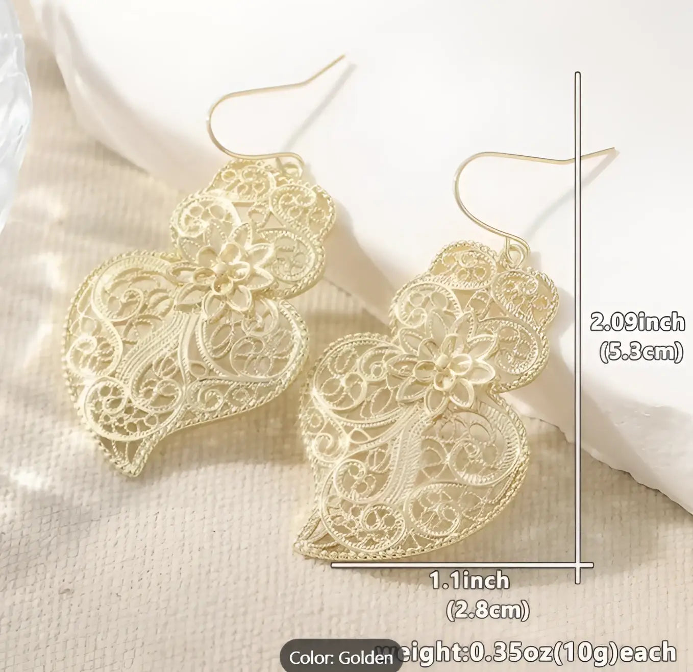Golden filigree earrings featuring vintage hollow carved heart design with intricate floral lace detailing