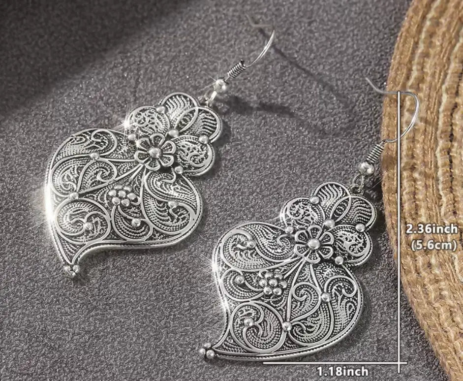 Filigree heart earrings in vintage silvery copper featuring intricate floral patterns and delicate maxi-hook style design