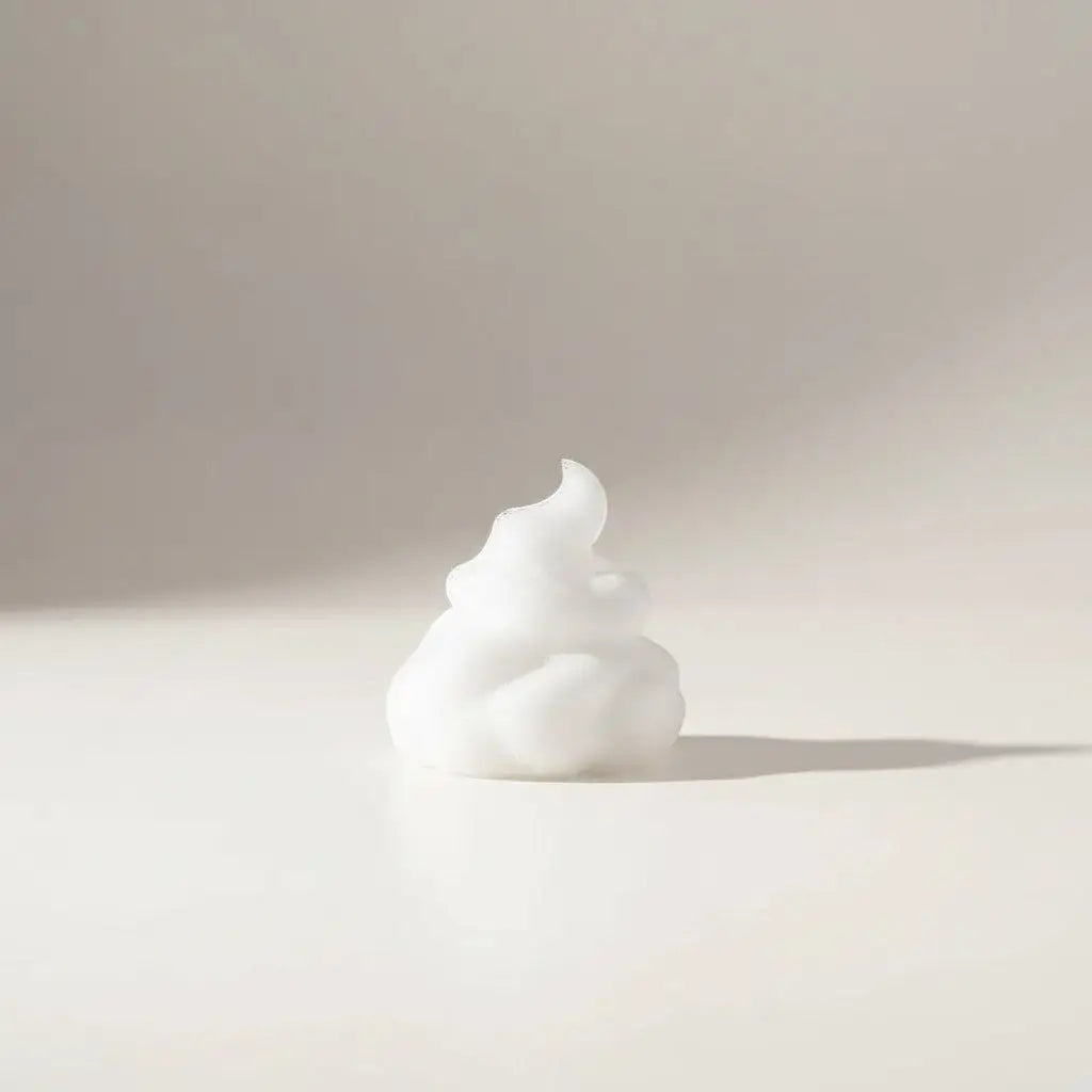 A dollop of creamy white foaming hand soap with a soft frothy texture for gentle hand cleansing