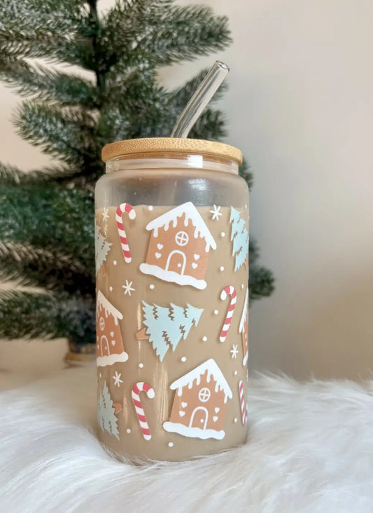 Clear glass gingerbread house cup with festive decals and a stylish bamboo lid featuring a reusable glass straw