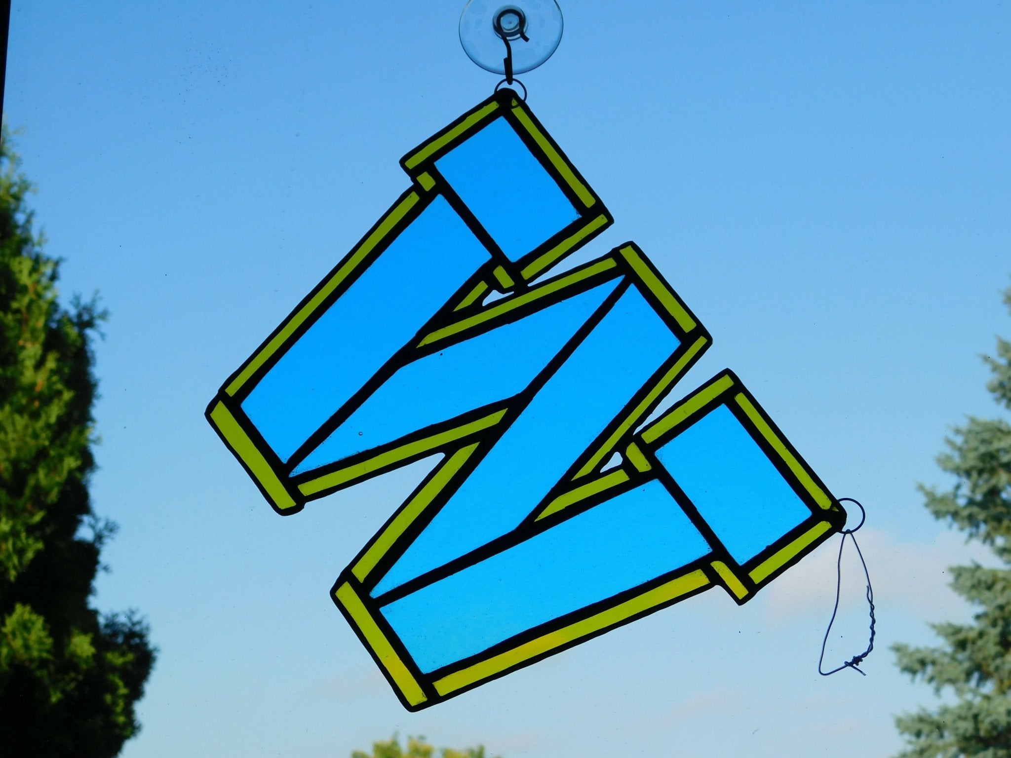Go Blue Go this colorful stained glass logo in Sky - blue, trimmed with gold colored glass, is an eye catcher at 8 1\2 in x 7 1\2 in . this could go in a window or sit on a shelf - Pure Wash Canadian Made - Winnipeg