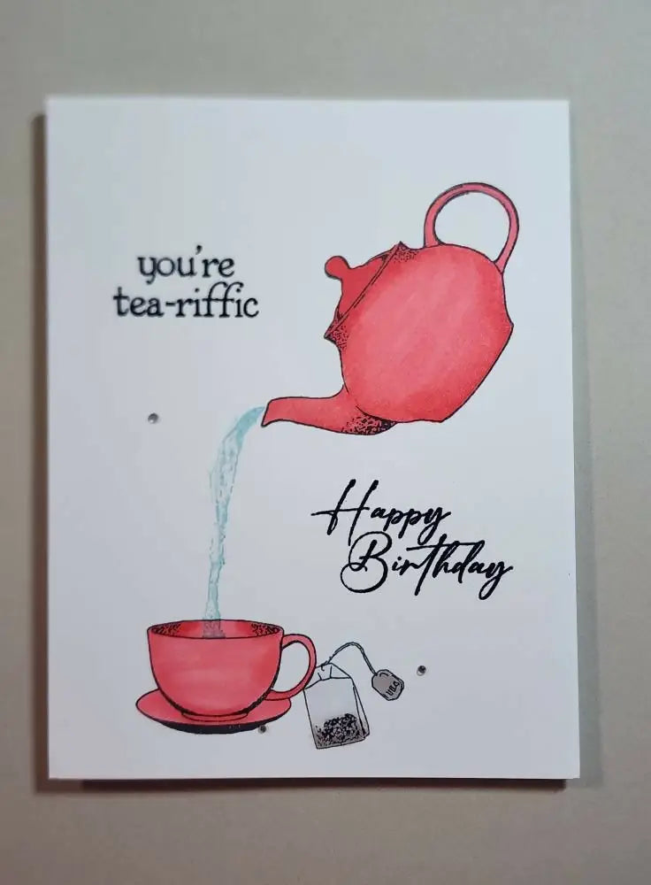 A vibrant red hand-drawn teapot pouring tea on a white handmade greeting card for natural skincare Canada fans