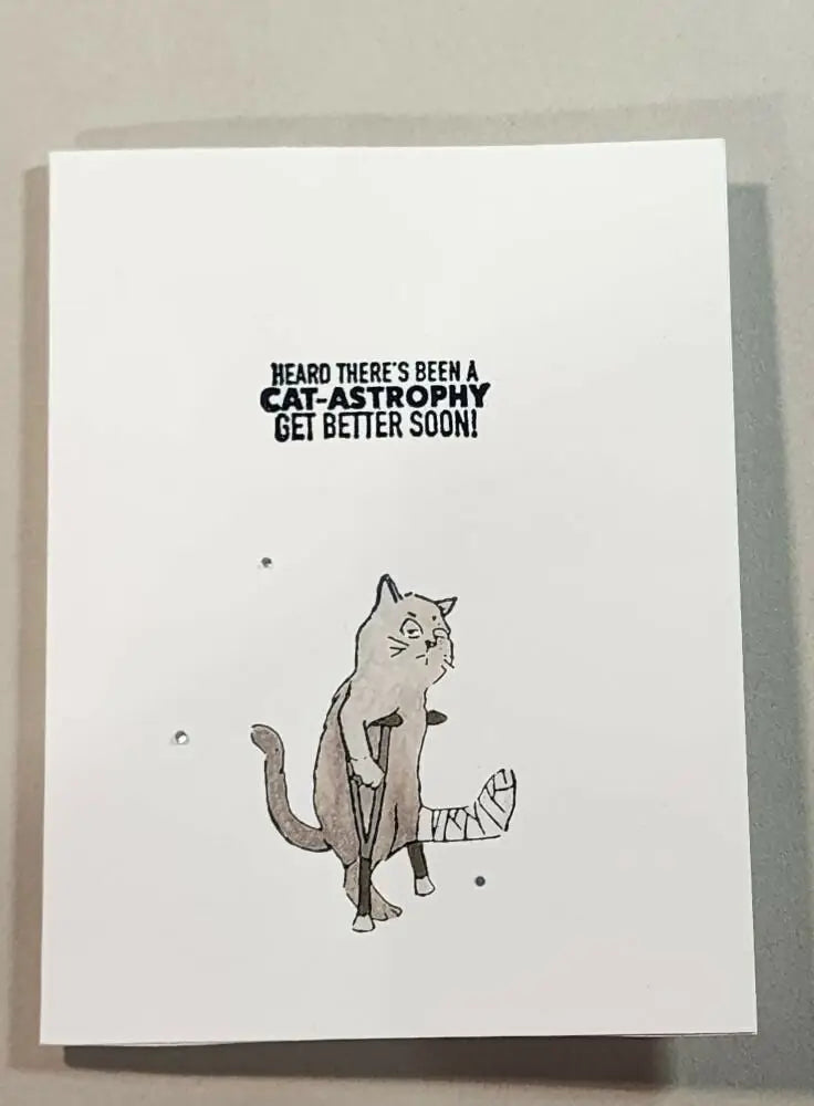 White greeting card with black ink illustration of injured cat and get better soon text ideal for greeting card use