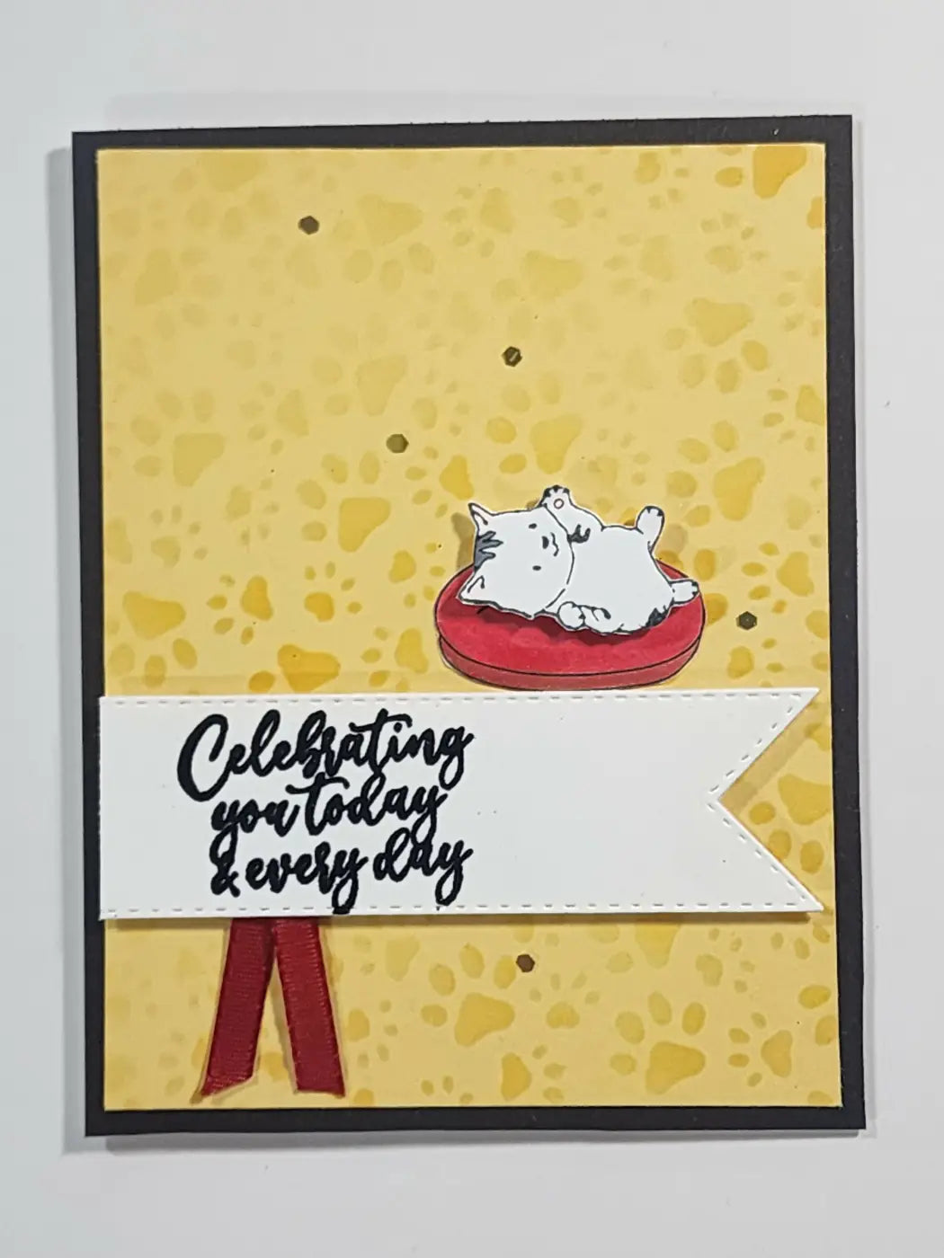 Greeting card featuring a white cartoon cat with black eyes lying on a red cushion, ideal for natural skincare canada gifts