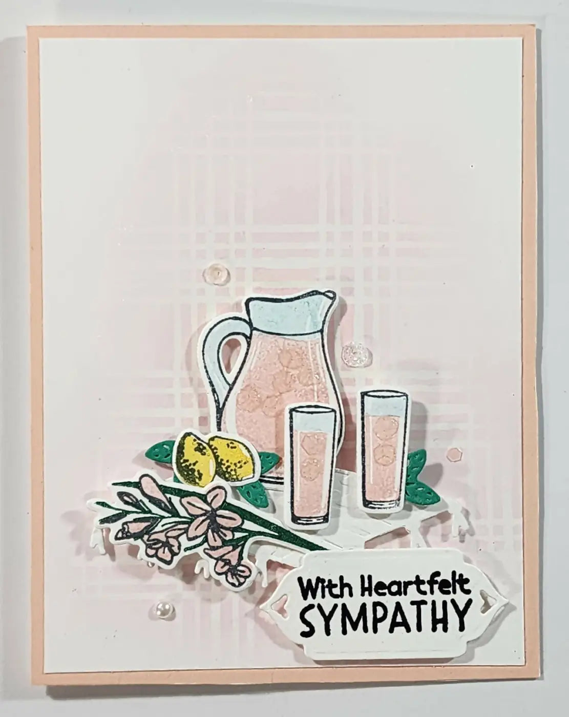 A delicate pink greeting card featuring a translucent pitcher with a light blue rim and floral patterns for canadian made skincare