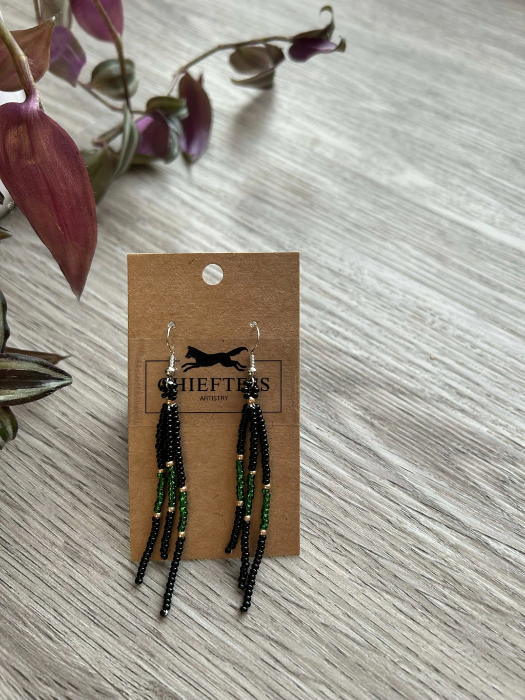 Beaded dangle earrings with 3-inch length on display card.