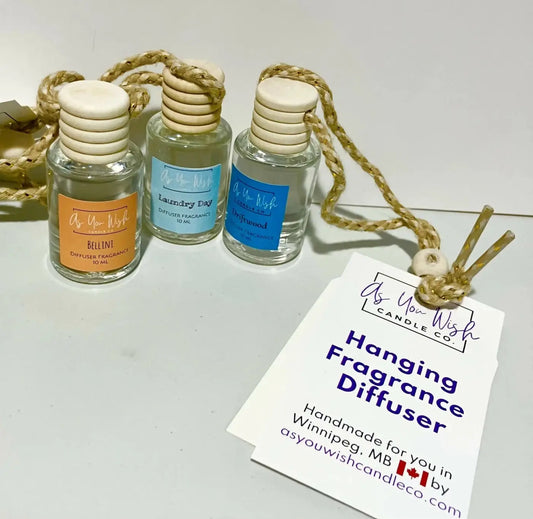 Three clear glass hanging fragrance diffusers with wooden caps and braided rope ties from as you wish candle co