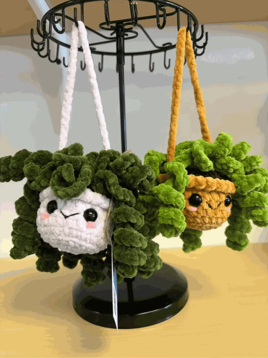Handmade crochet hanging plant keychain with white face green curly vines black bead eyes perfect for pure wash use