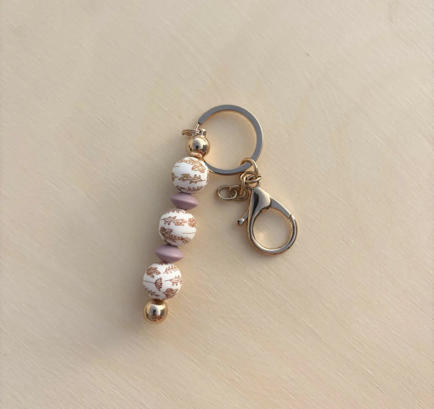 Heirloom silicone bead keychain with white gold leaf and lavender matte beads on silver ring for diaper bag accessories