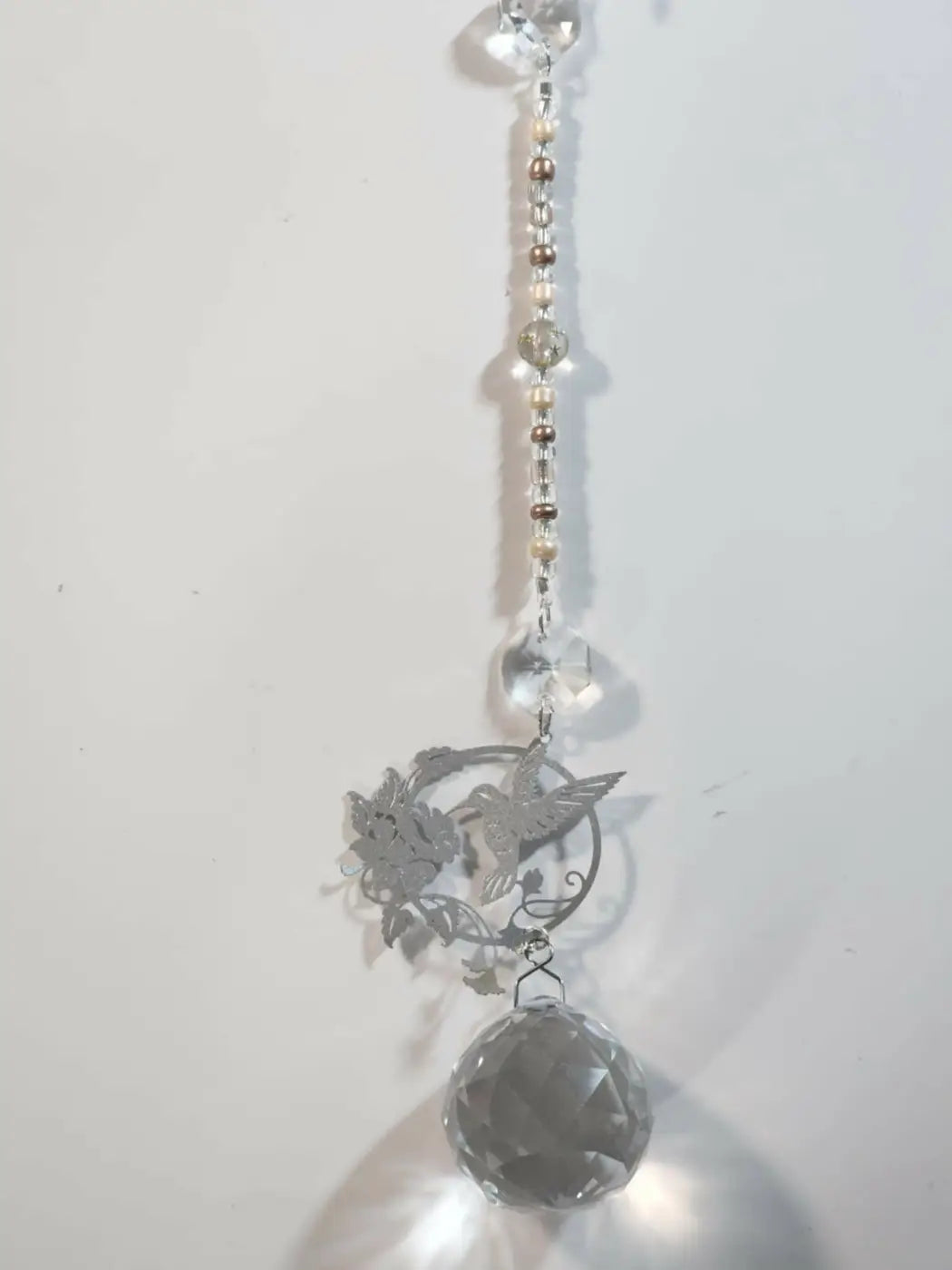 Silver hummingbird and floral design sun catcher with iridescent ornament and clear crystal light catcher beads
