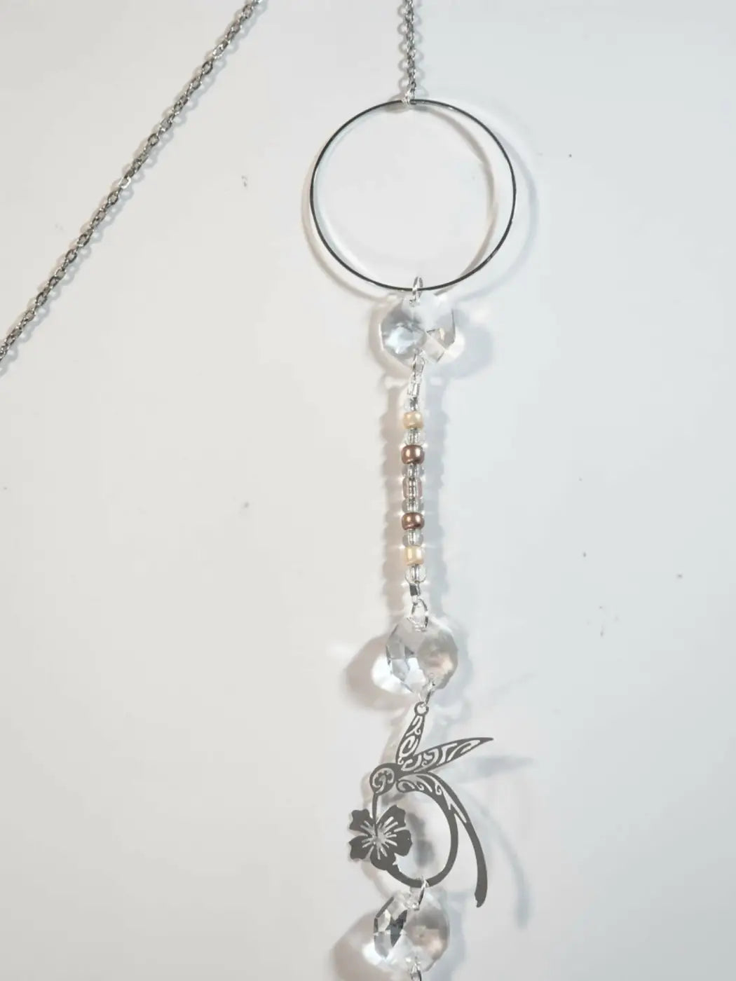 Silver-toned hummingbird 2 long suncatcher with clear crystal beads, metallic floral charms, and small reflective light catcher