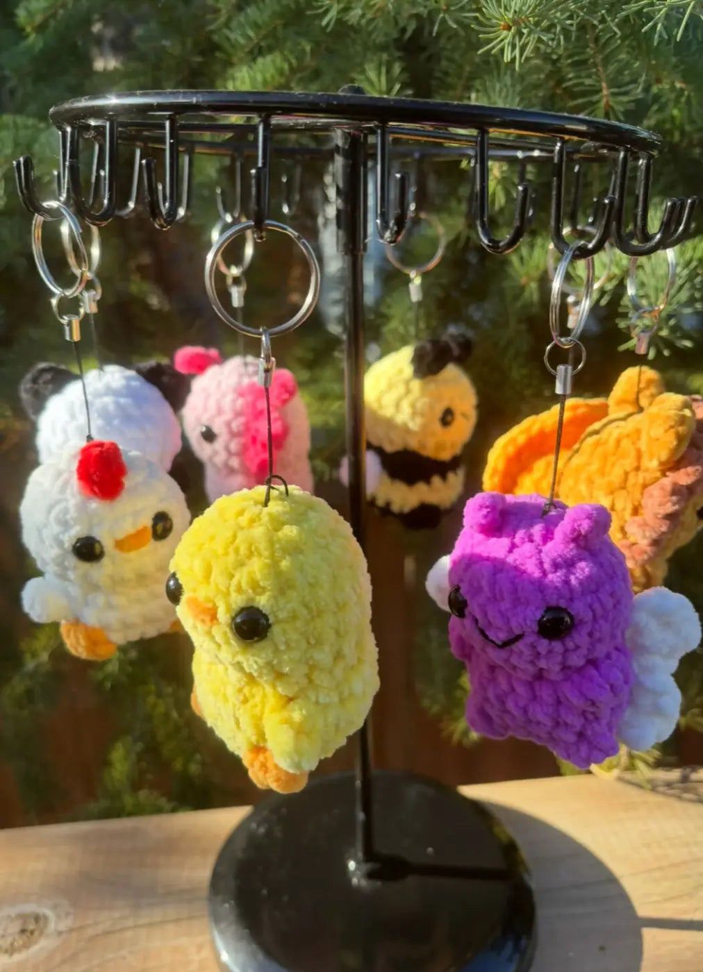 Yellow crocheted chicken keychain with black bead eyes and orange feet for decorative options include chicken accessories