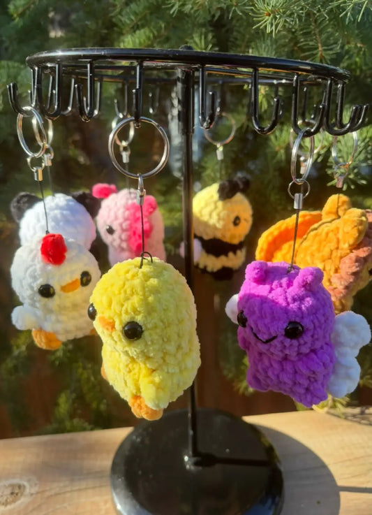 Yellow crocheted chicken keychain with black bead eyes and orange feet for decorative options include chicken accessories