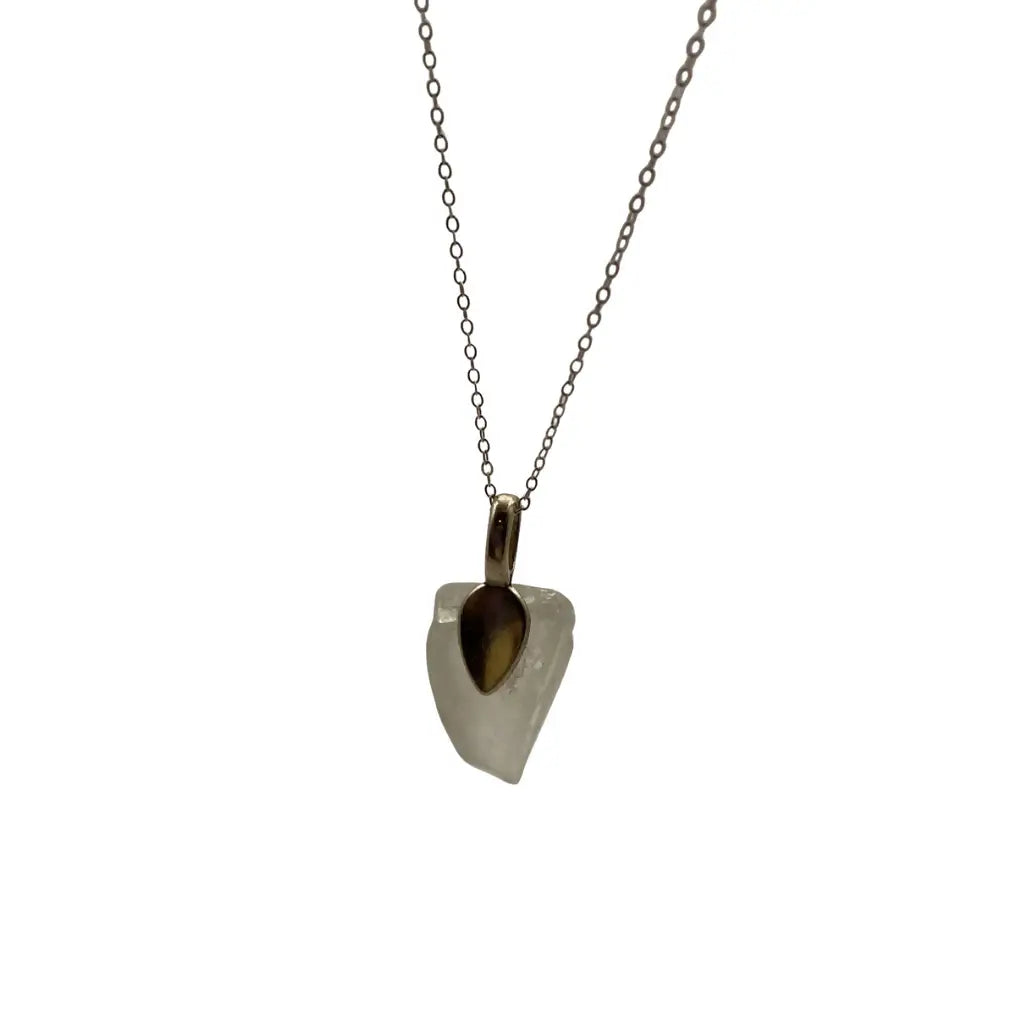 Large clear beach glass pendant features a translucent white quartz teardrop with amber accent on a delicate silver chain