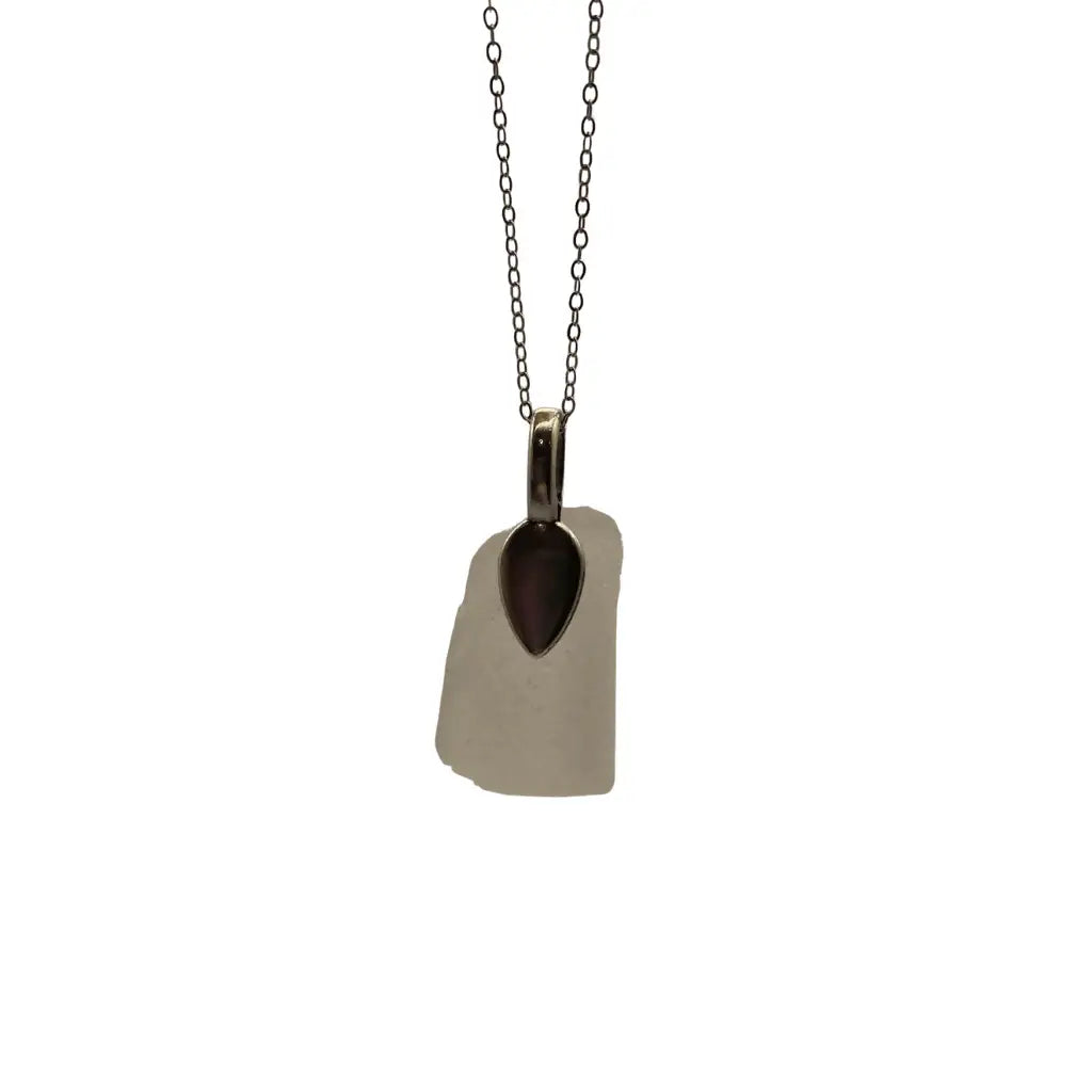 Minimalist large clear beach glass pendant necklace with smooth translucent white sea glass and dark brown accent stone