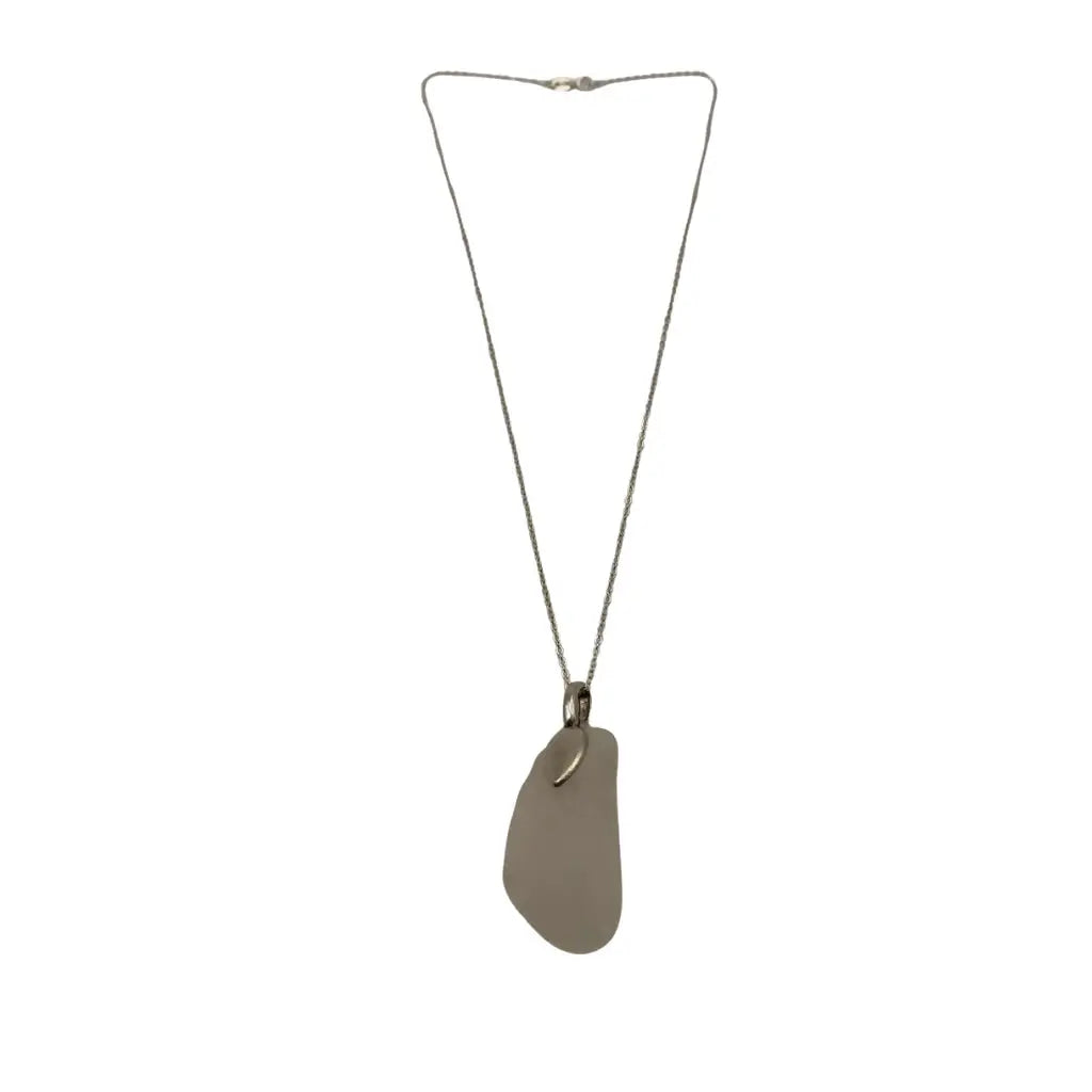 A large clear beach glass pendant necklace with a smooth translucent gray sea glass and silver-toned chain