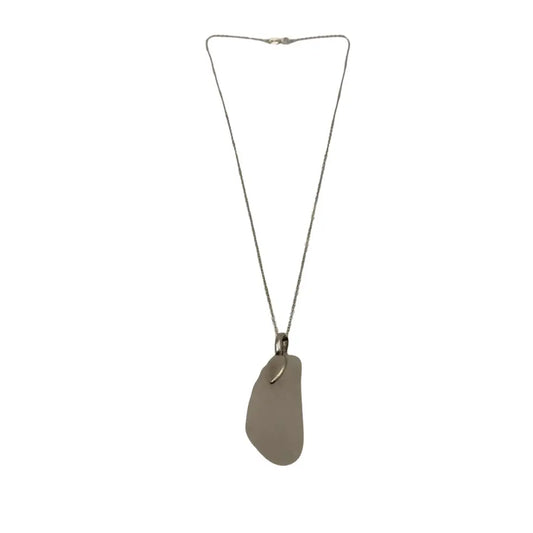 A large clear beach glass pendant necklace with a smooth translucent gray sea glass and silver-toned chain