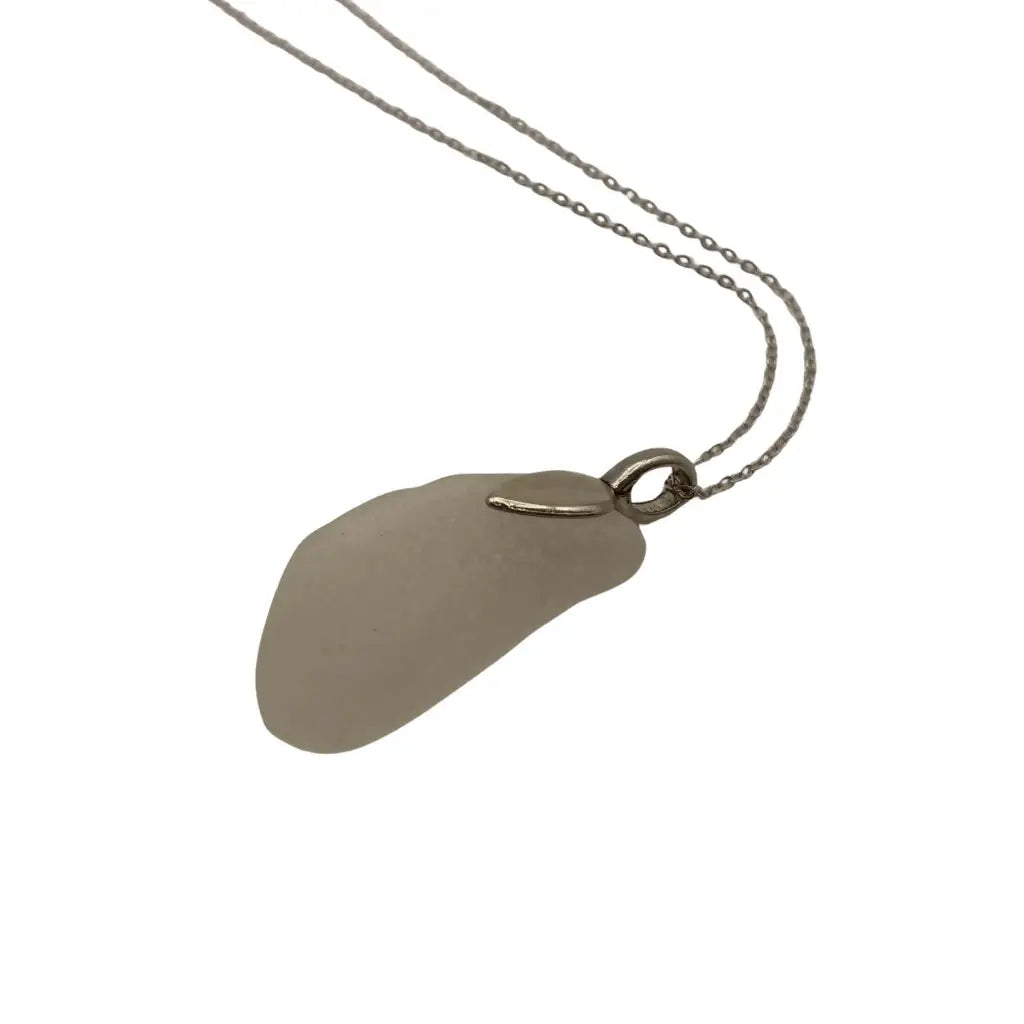 Large clear beach glass pendant with pale gray smooth sea glass and silver-toned metal bail and chain showcasing prairie history