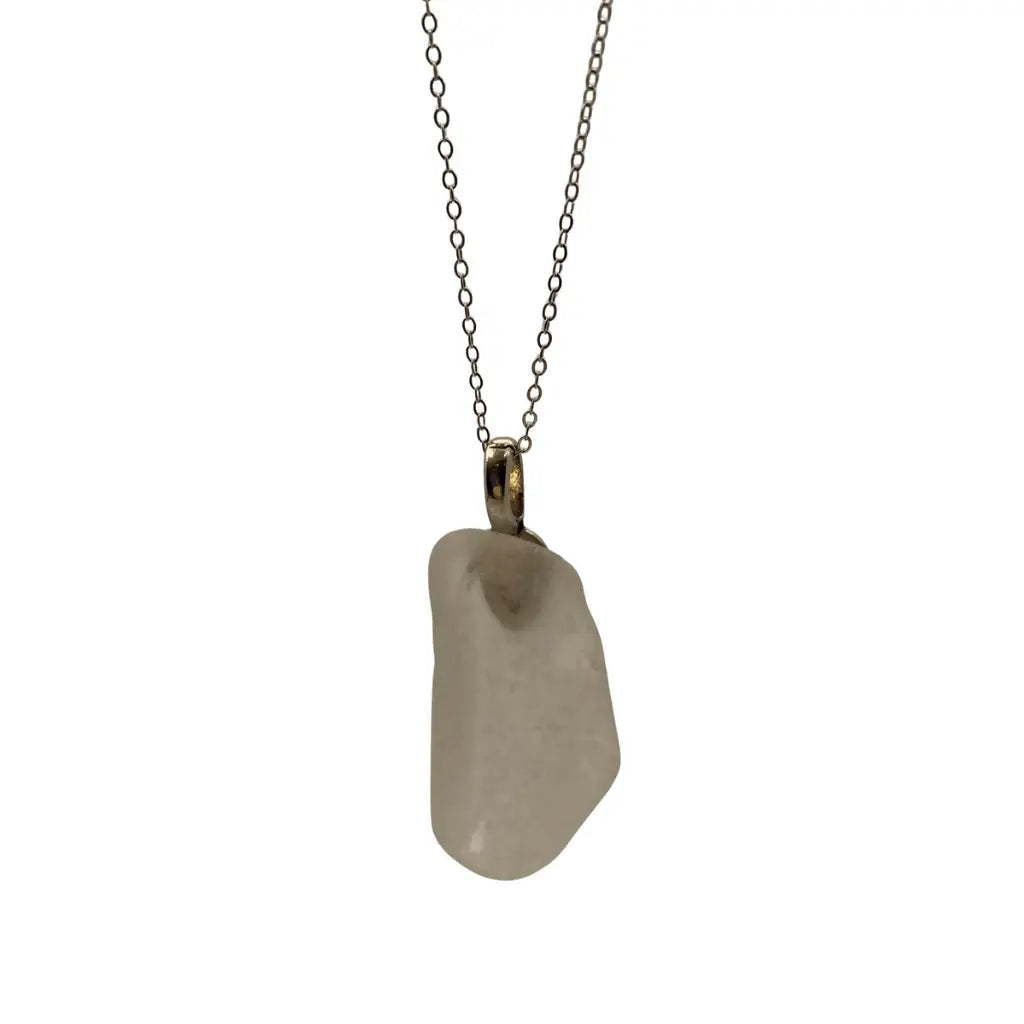 A large clear beach glass pendant featuring smooth translucent white sea glass on a delicate silver chain