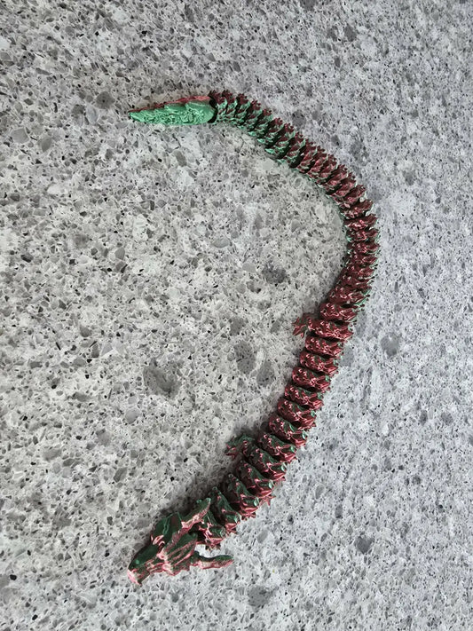 Large dragon metallic necklace with green head and red segmented body featuring detailed scales, ideal for canadian made skincare gifts