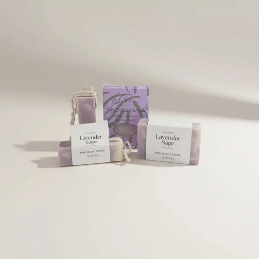 Lavender sage soap bars in soft purple wrapped with white labels and tied with delicate rope featuring clary sage and palm oil