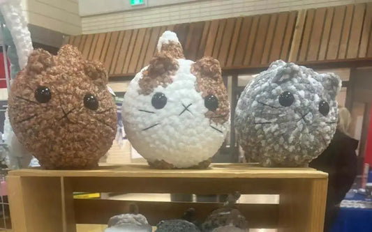 Three handmade loaf cats crocheted with textured yarn in distinct color patterns ideal for pure wash use canada