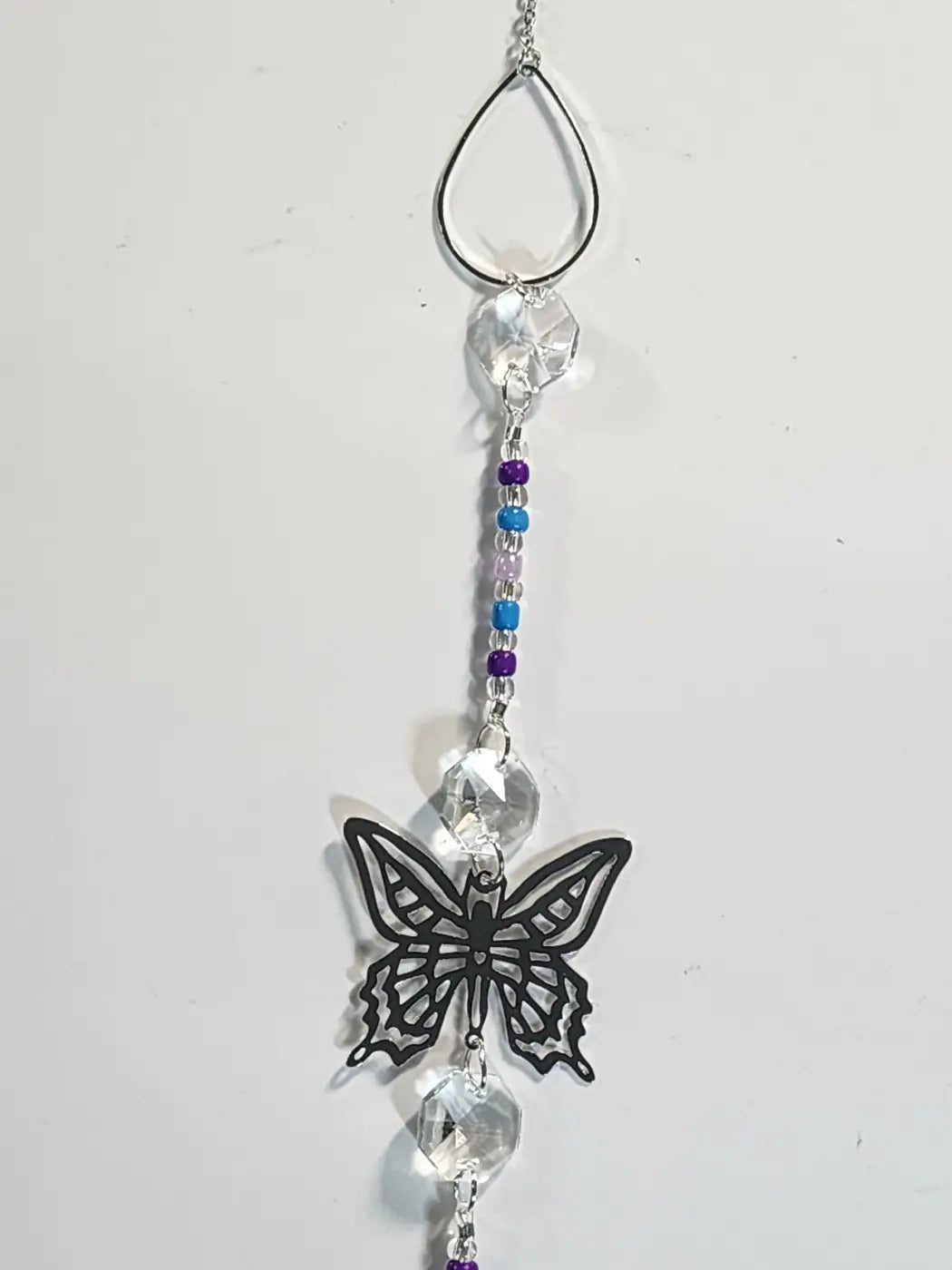 Long 4 delicate black butterfly-shaped suncatcher with crystal beads and purple-blue accents for direct sunlight display