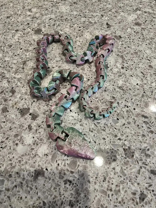 Long snake metallic iridescent necklace with segmented design and pink green blue gradient hues perfect for stylish wear
