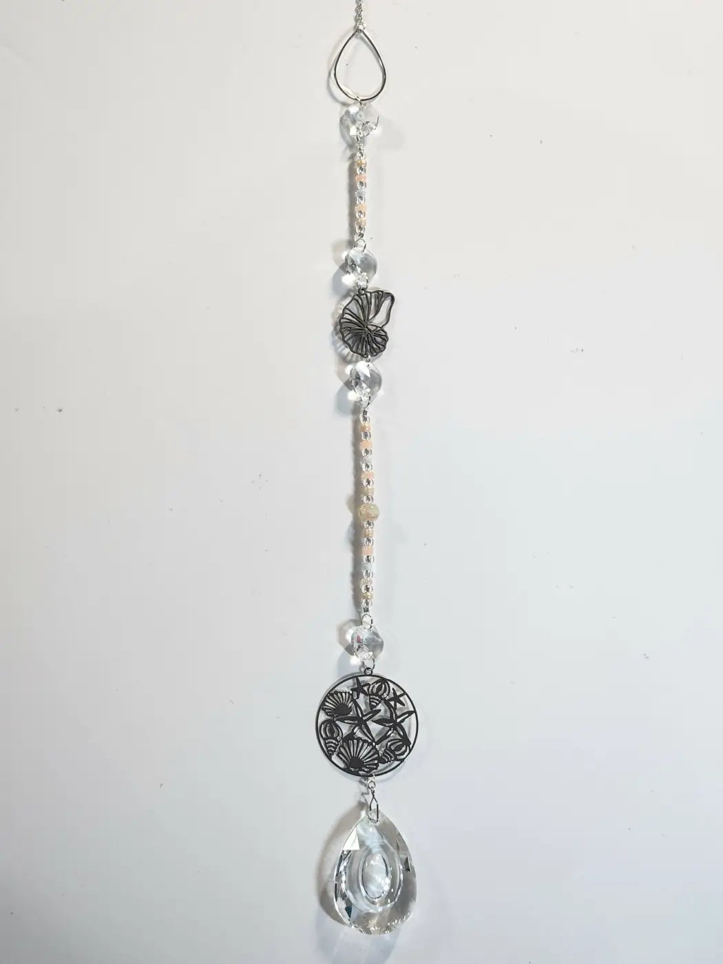 Long suncatcher with clear crystal, silver hook, and black filigree butterfly design for direct sunlight display