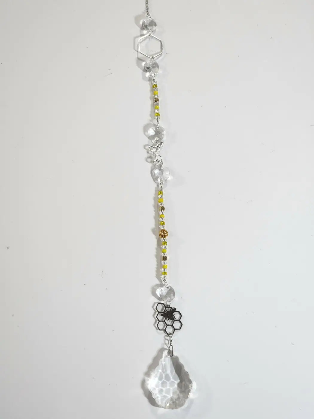 Long suncatcher with honeycomb crystal, silver hexagonal top, and yellow brown beads for direct sunlight display