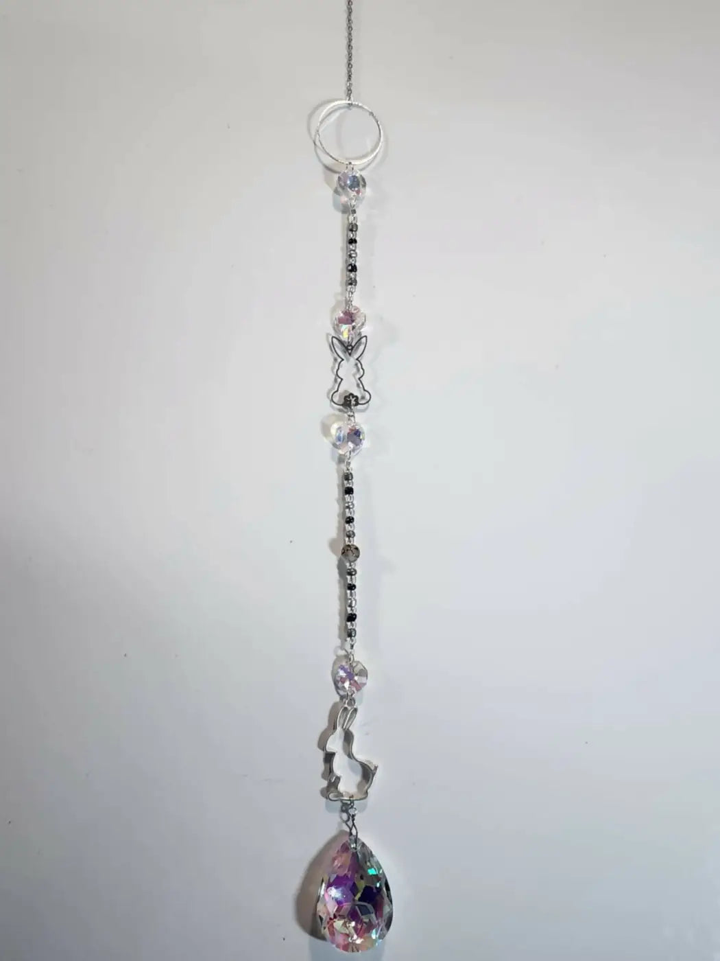 Delicate silver-toned long suncatcher with clear and black beads, bunny charms, and iridescent crystal pendant for direct sunlight use