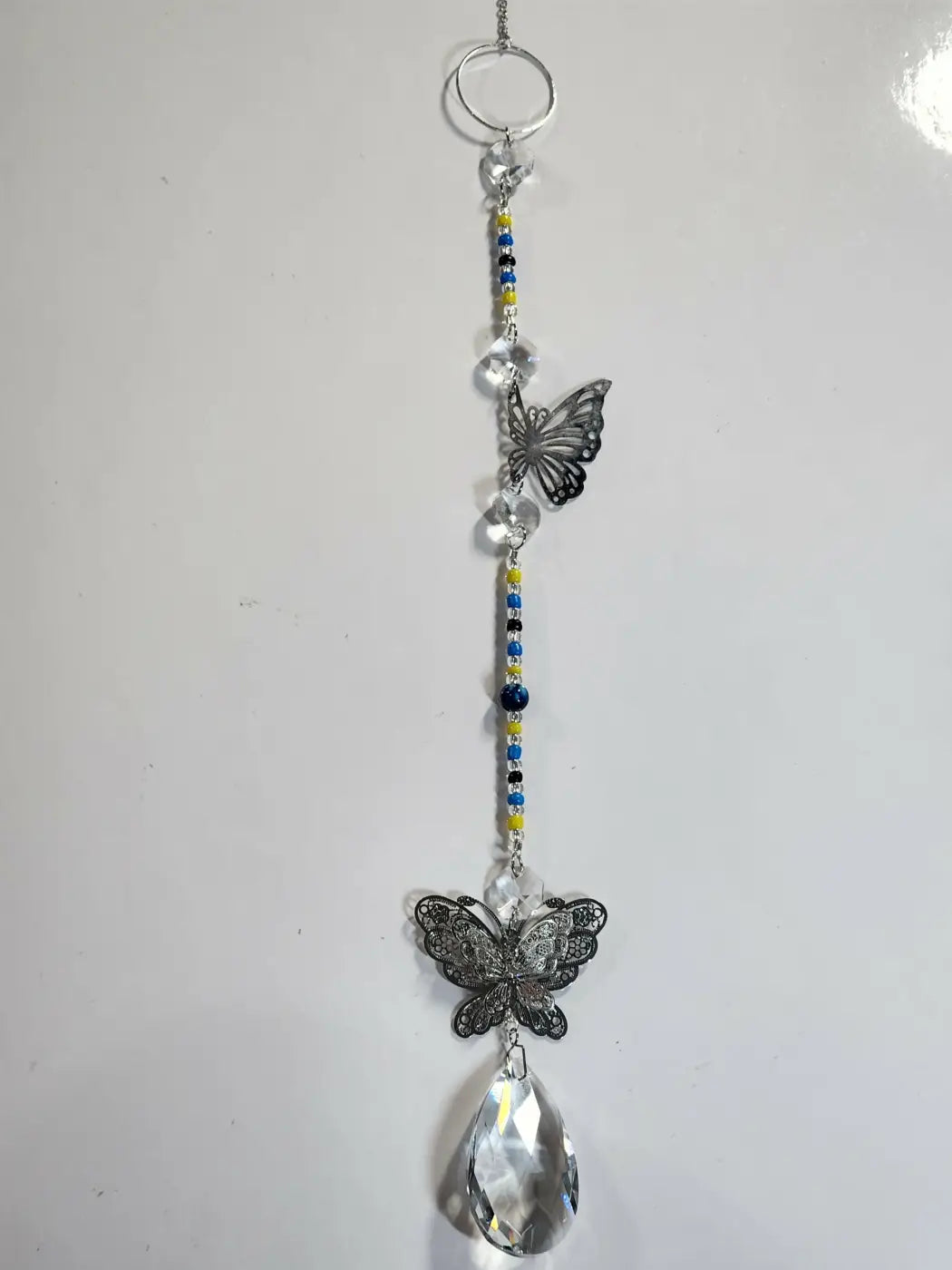 Silver-toned butterfly long suncatcher with clear crystal beads blue and yellow accents for direct sunlight display