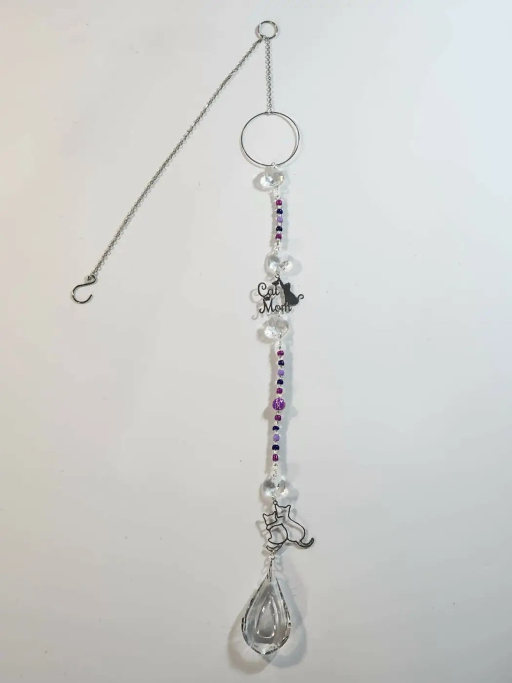 Long suncatcher with silver-toned cat design, clear and purple beads, teardrop crystal, and cat mom charm for direct sunlight