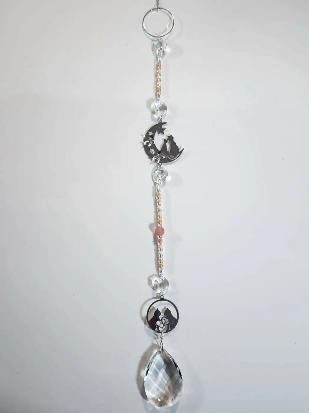 Long suncatcher with silver chain clear and rose beads featuring cat on moon and rose charms for direct sunlight display