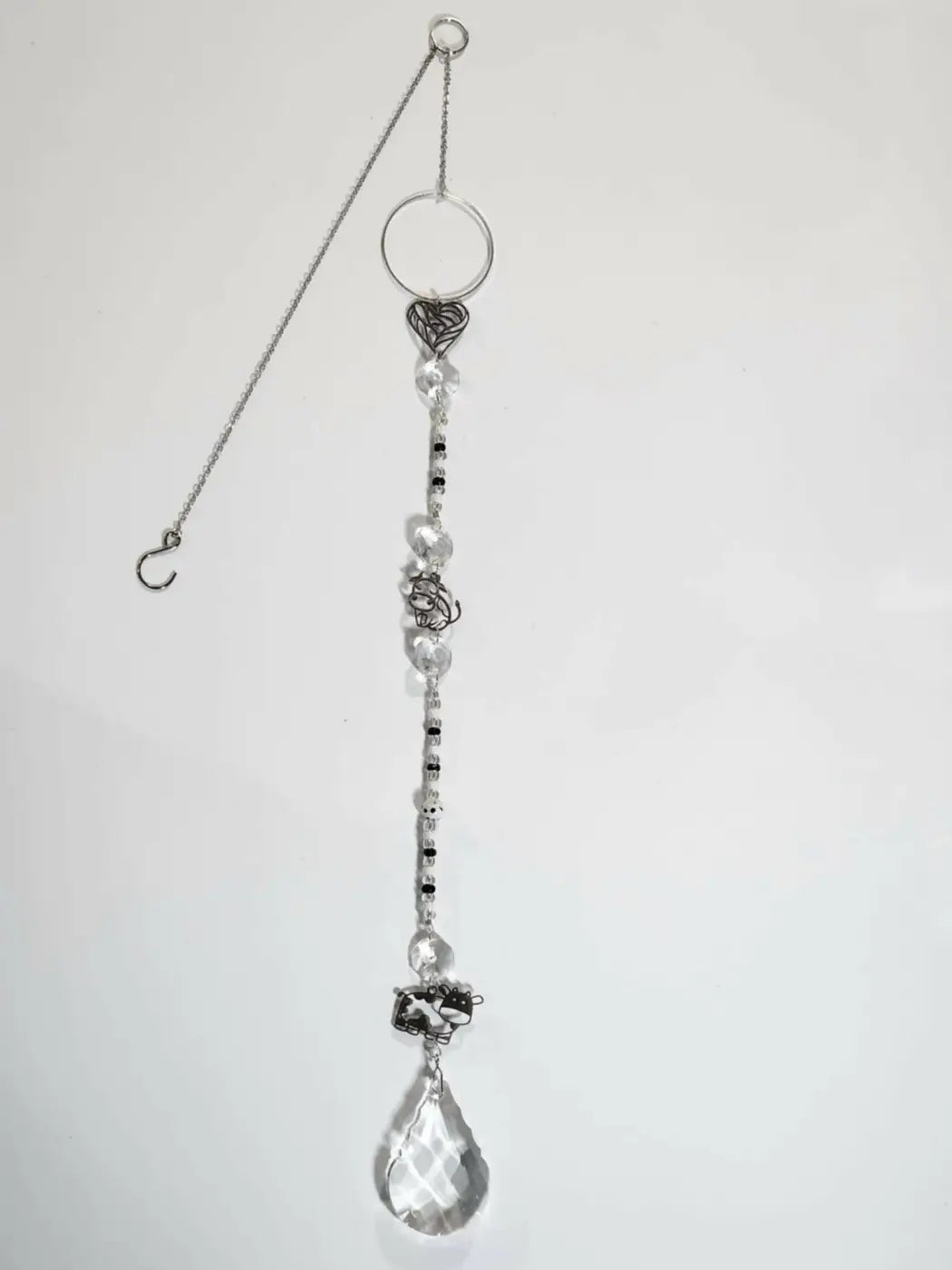 Long suncatcher with silver chain, heart charm, clear and black beads, and crystal teardrop for direct sunlight display