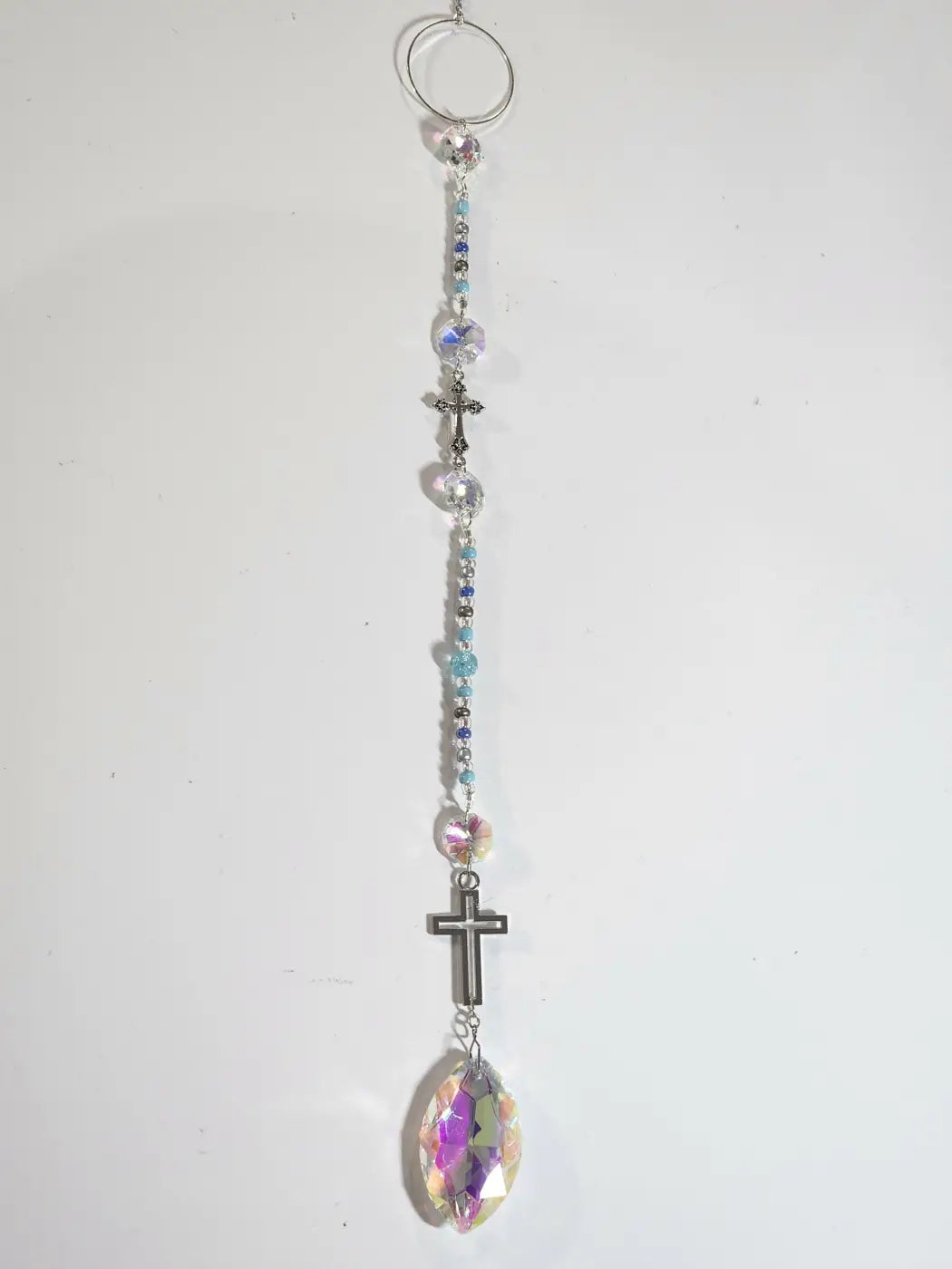 Long suncatcher featuring a delicate iridescent crystal rosary with silver crosses and prism for direct sunlight display